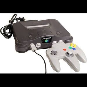 Nintendo 64 with a remote and Mario party and Zeld